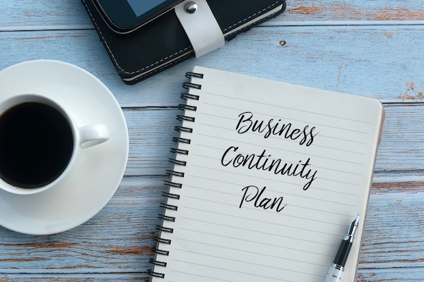 Business continuity plan written on journal